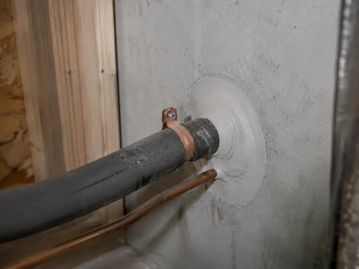 Refrigerant line set passing through a mechanical room wall